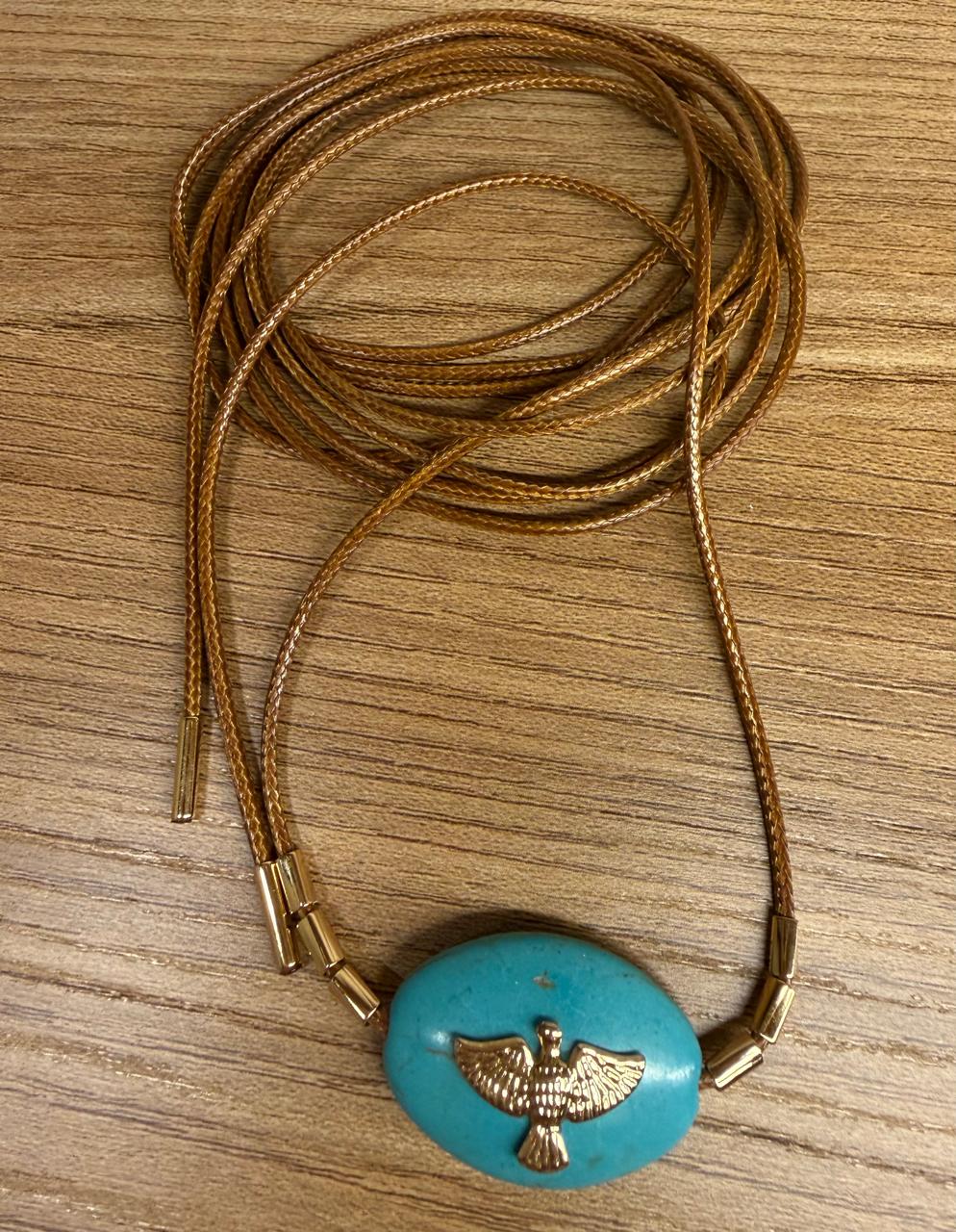 Colar longo para várias voltas, cordão encerado com pingente turquesa oval com um Divino Espirito Santo no banho de ouro ao centro, ponteira e canutilhos. 1,80cm
